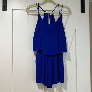 Royal blue flowy romper with front pockets